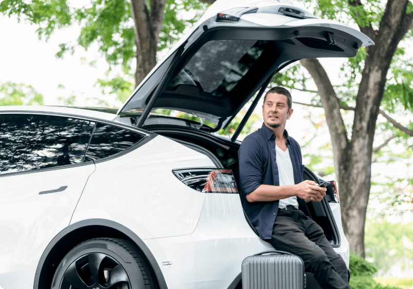 Man sitting in the trunk of a car