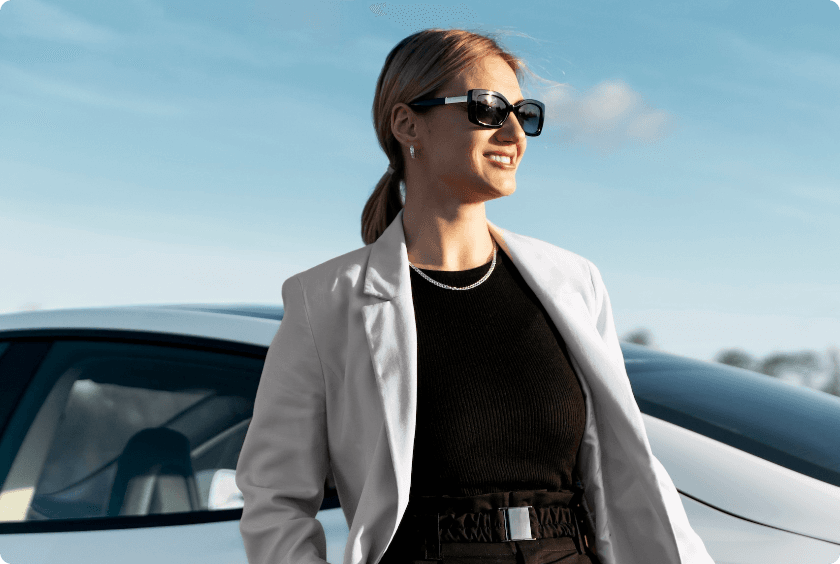 Woman posing next to a car