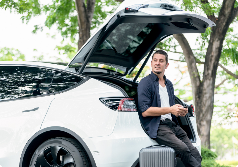 Man sitting in the trunk of a car