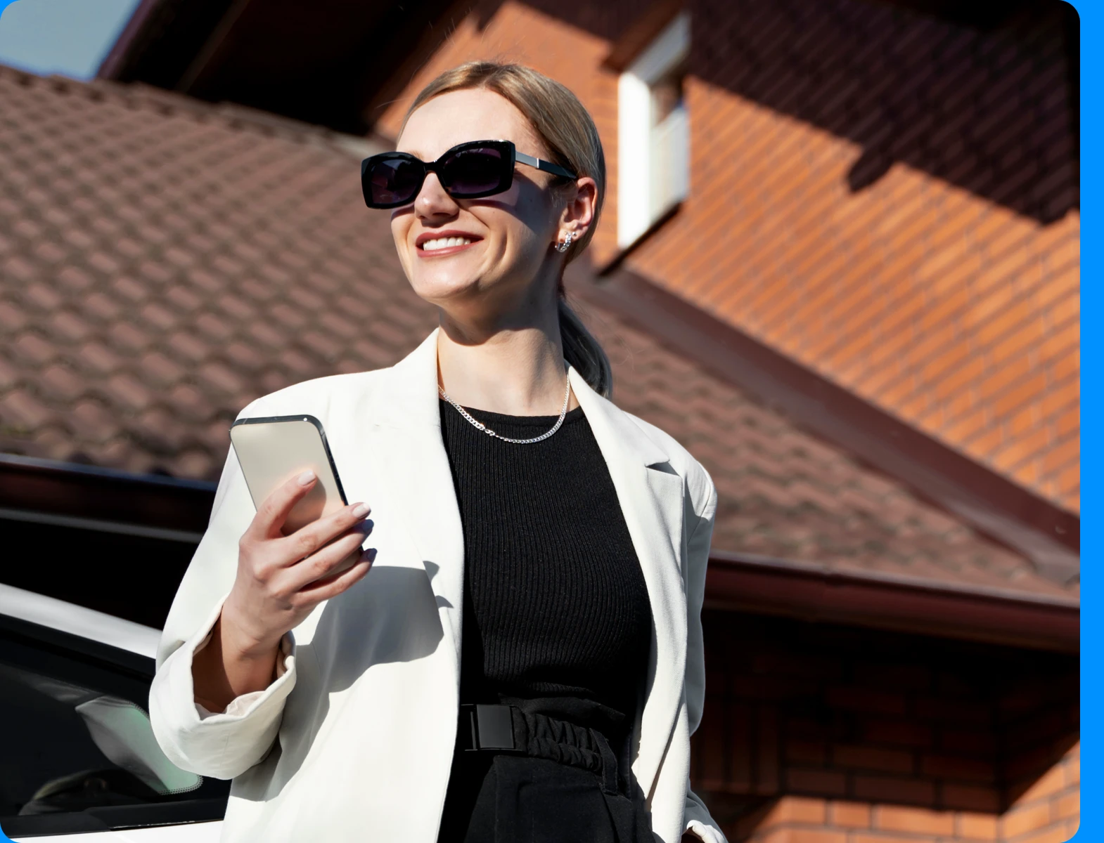 A buyer standing beside her new vehicle